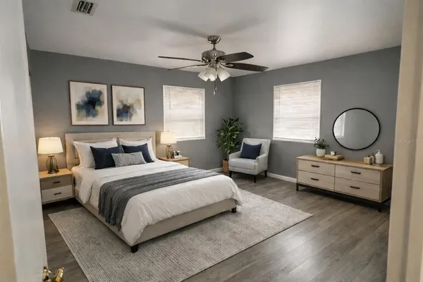 a bedroom with bed and a chandelier