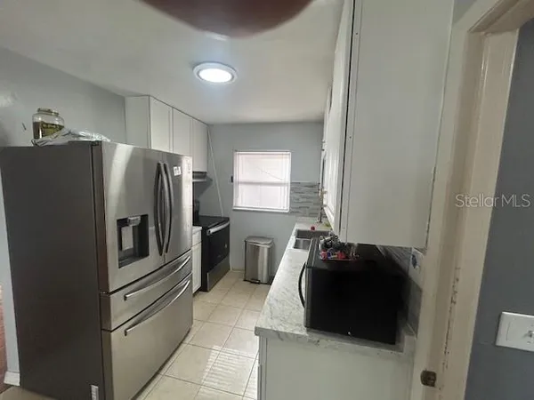 a kitchen with a refrigerator and window