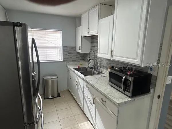 a kitchen with stainless steel appliances a refrigerator sink and stove