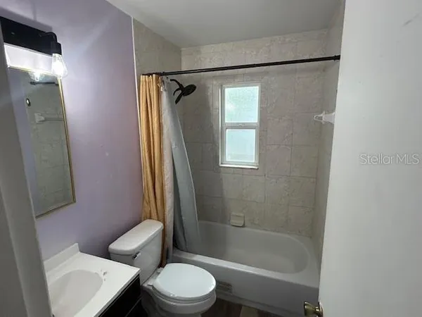 a bathroom with a toilet a sink and a shower