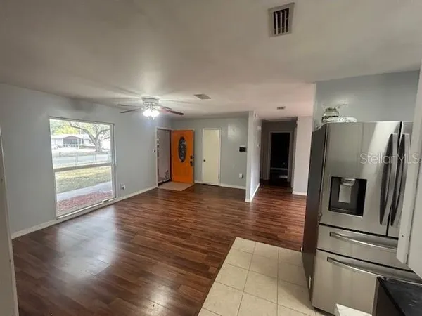 a view of a refrigerator in kitchen and wooden floor
