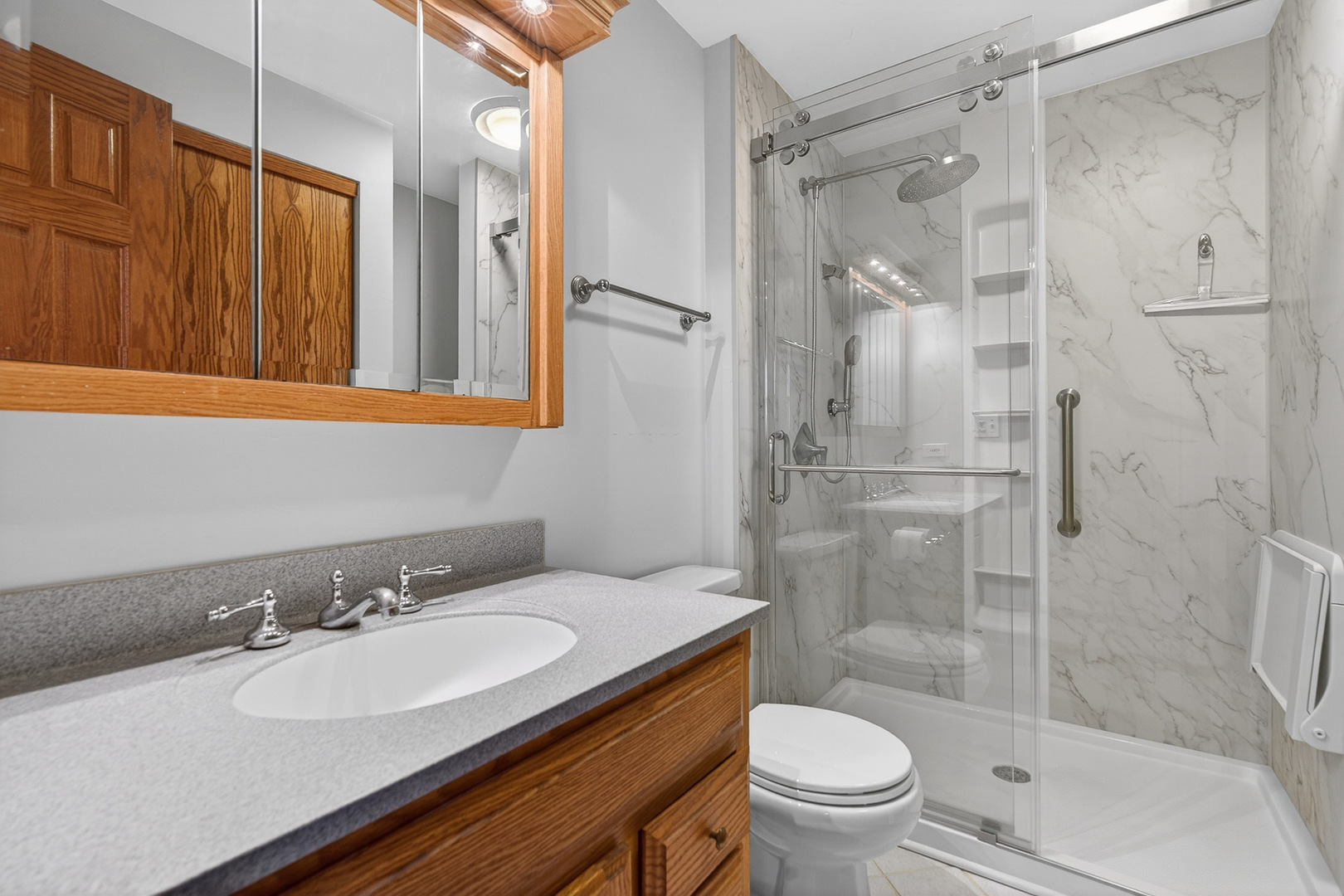 1790 Devonshire Court Elgin, IL 60123 - Photo 12 of 27 a bathroom with a sink toilet and shower