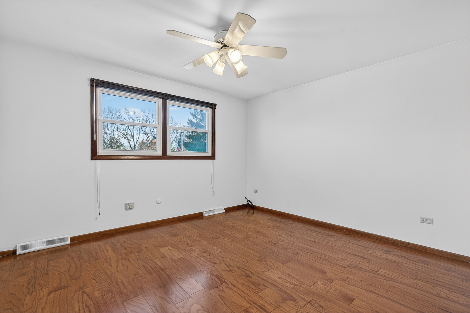 1790 Devonshire Court Elgin, IL 60123 - Photo 14 of 27 wooden floor in an empty room with a window