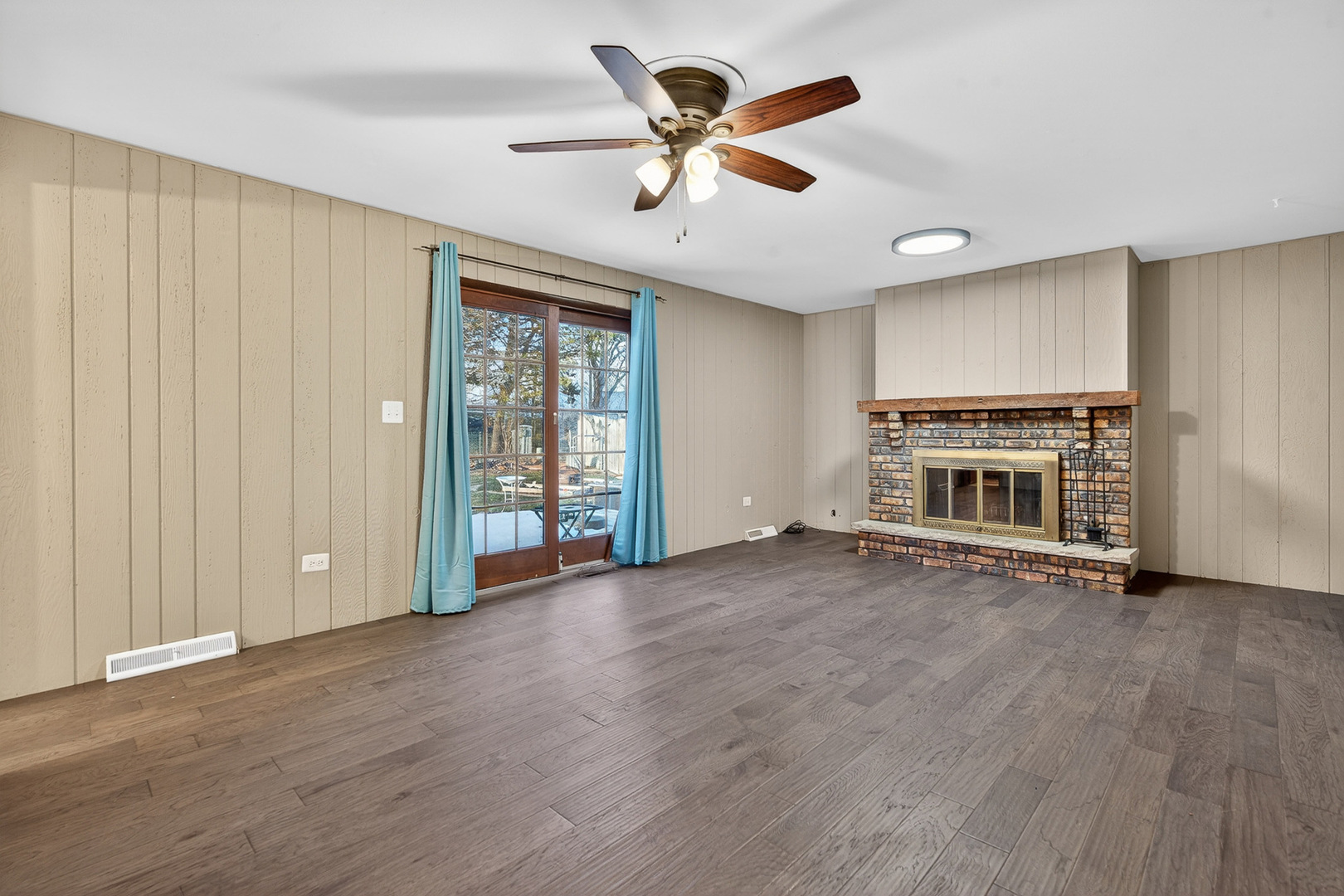 1790 Devonshire Court Elgin, IL 60123 - Photo 16 of 27 an empty room with wooden floor a ceiling fan and windows