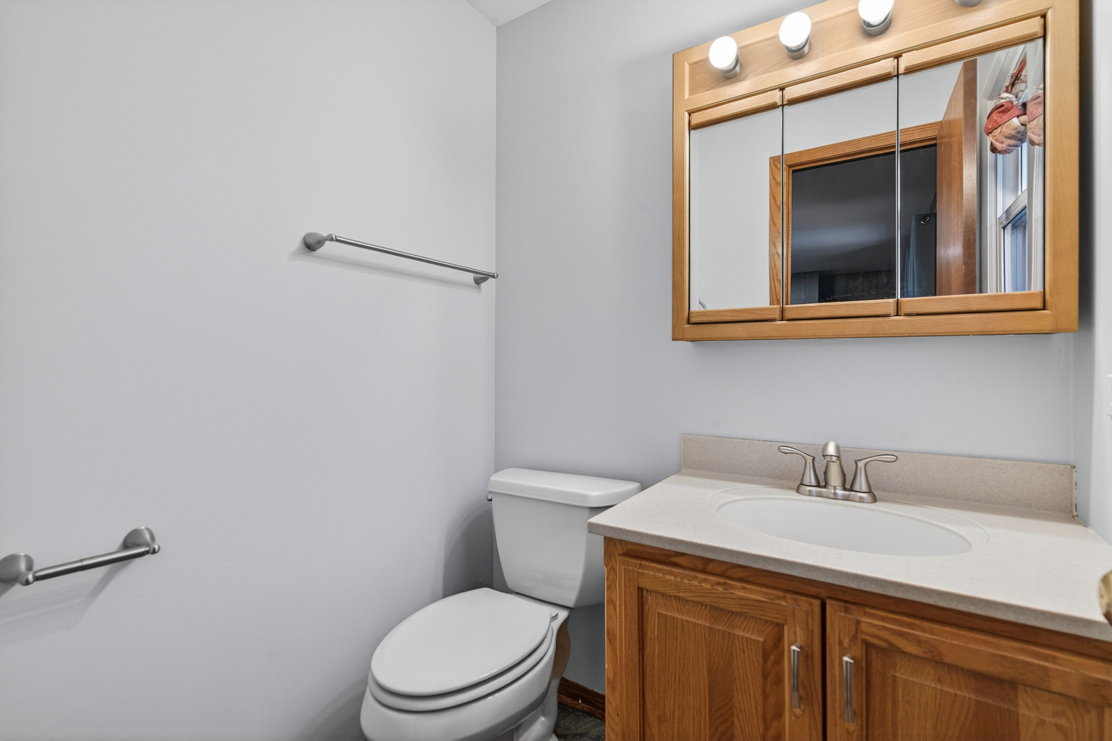 1790 Devonshire Court Elgin, IL 60123 - Photo 18 of 27 a bathroom with a toilet sink and mirror