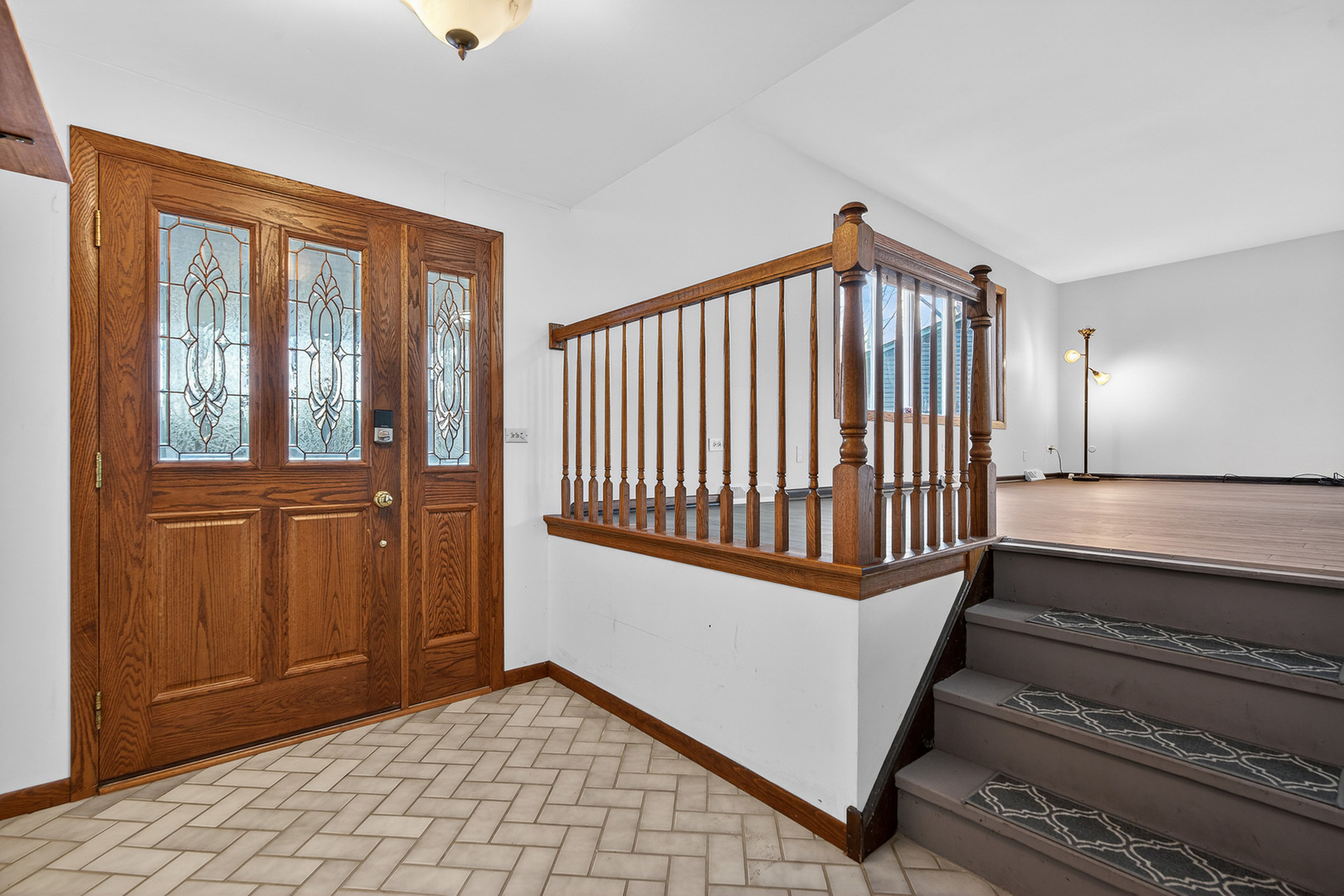 1790 Devonshire Court Elgin, IL 60123 - Photo 19 of 27 a view of a hallway with wooden floor and staircase