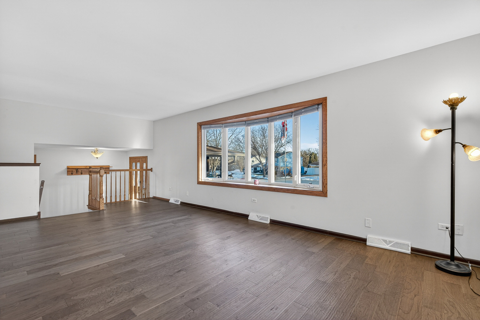1790 Devonshire Court Elgin, IL 60123 - Photo 4 of 27 a view of an empty room with wooden floor and a window