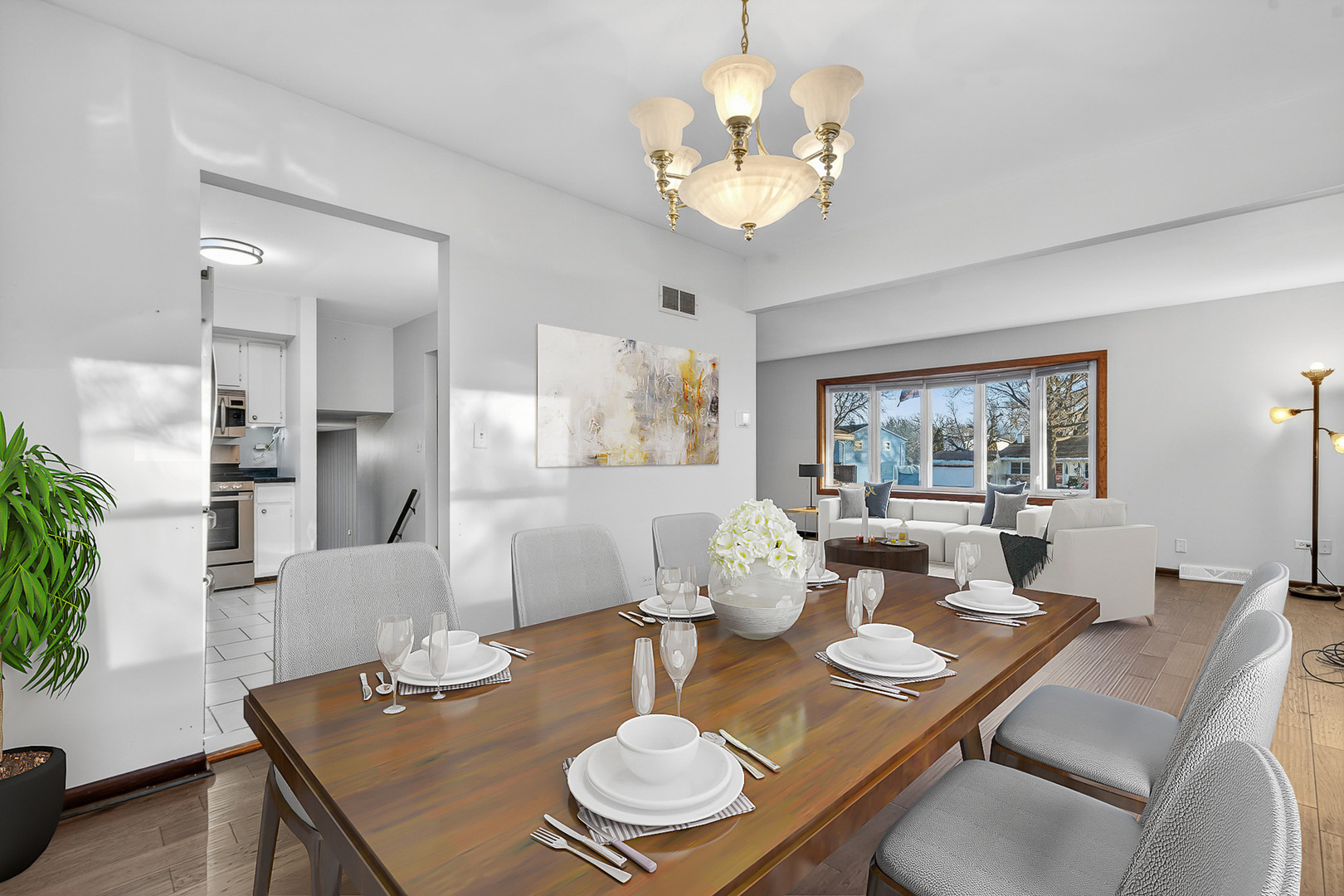 1790 Devonshire Court Elgin, IL 60123 - Photo 6 of 27 a dining room with furniture a chandelier and wooden floor