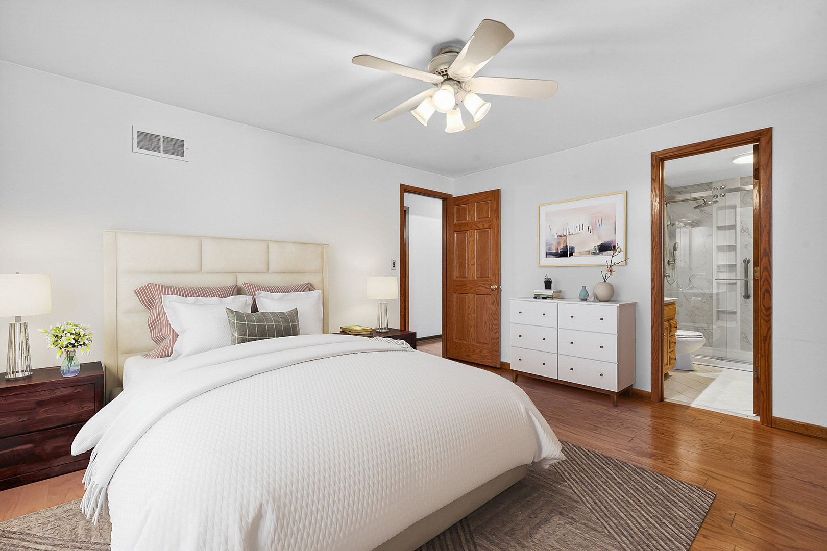 1790 Devonshire Court Elgin, IL 60123 - Photo 10 of 27 a spacious bedroom with a bed and a chandelier