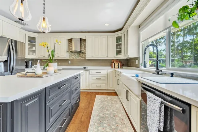 a kitchen with a sink stove and cabinets