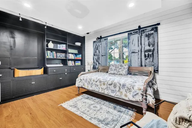 a bed sitting in a bedroom next to a window