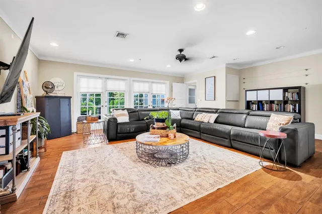 a living room with furniture a rug and a large window