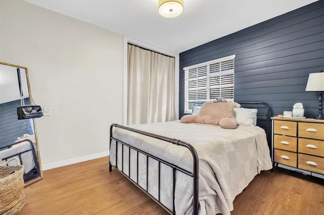 a bedroom with a bed and a dresser