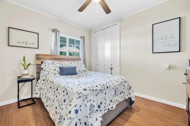 a bedroom with a bed and painting on the wall