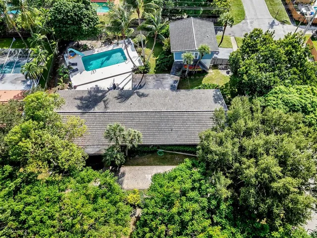 an aerial view of a house with a yard and garden