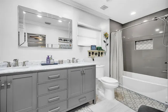 a spacious bathroom with a granite countertop sink toilet and shower