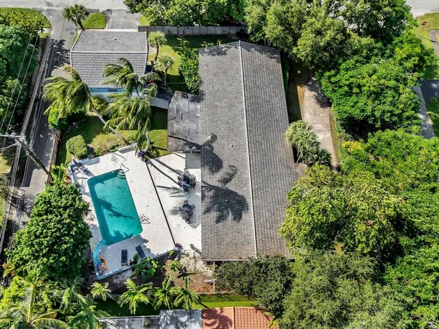 an aerial view of a house with a yard and a garden