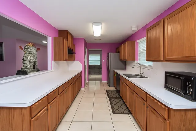 a kitchen with stainless steel appliances a sink dishwasher stove top oven and cabinets