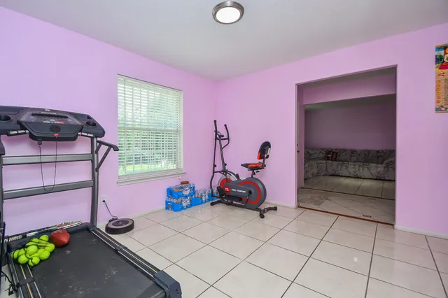 a view of a room with gym equipment and a large window