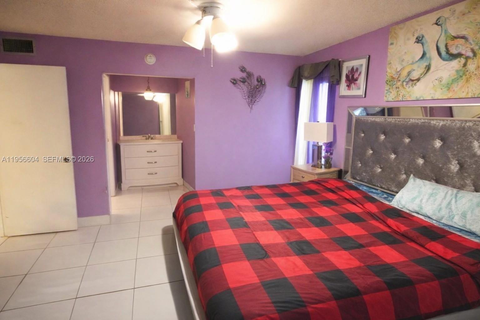3774 Inverrary Boulevard, Unit 101P Lauderhill, FL 33319 - Photo 11 of 11 a bedroom with a bed and a mirror