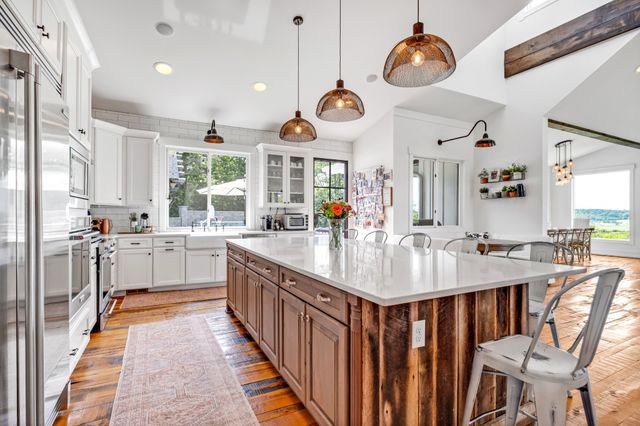 a large kitchen with stainless steel appliances kitchen island a large island in the center