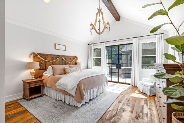 a bedroom with bed and wooden floor