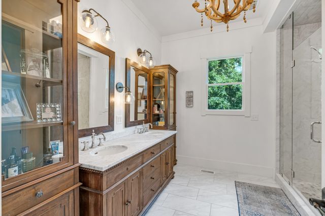 a bathroom with a sink a mirror and a shower