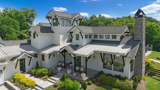 a view of a house with roof deck and furniture