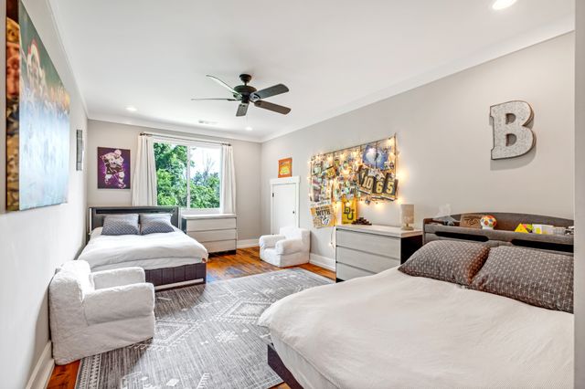 a bedroom with a bed a couch and a window