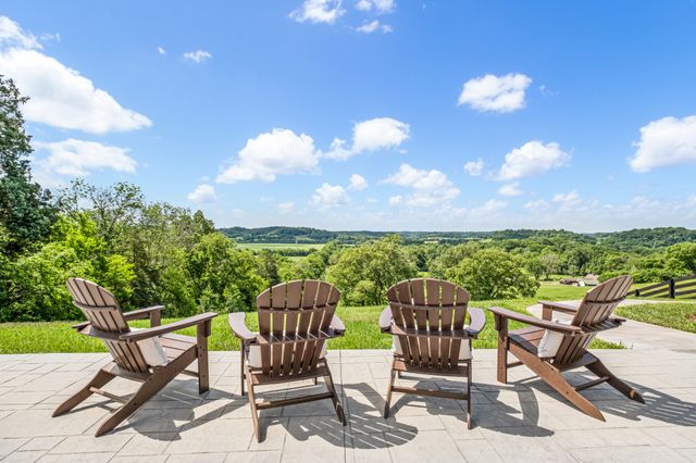 a view of a chairs and table in the patio