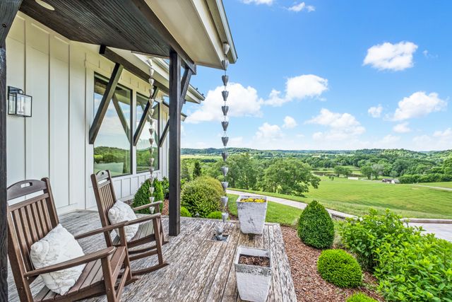 a view of a chairs and table in patio