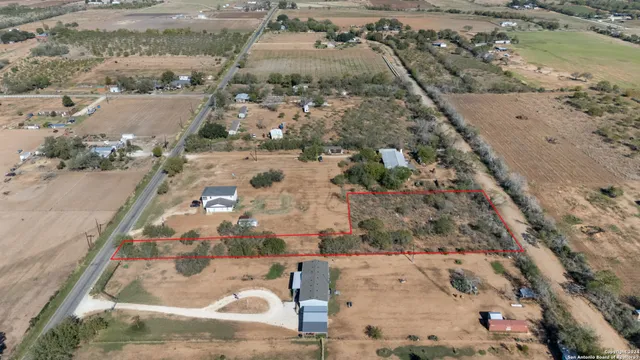 an aerial view of a house with a yard