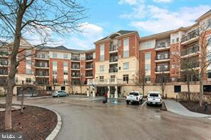 a city street lined with parked cars and buildings