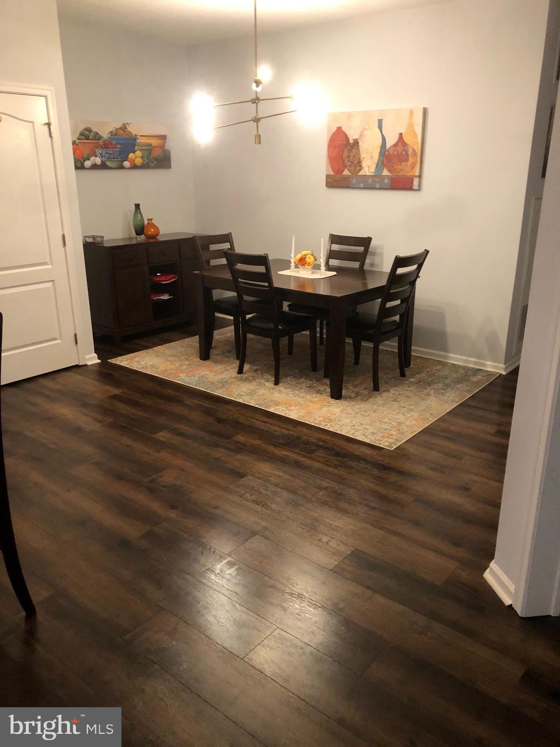 239 Carson Terrace, Unit 239 Huntingdon Valley, PA 19006 - Photo 4 of 19 a view of a dining room with furniture and wooden floor