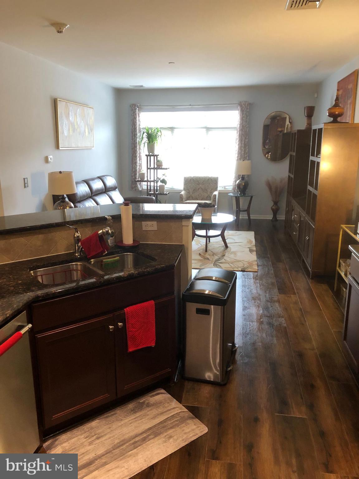 239 Carson Terrace, Unit 239 Huntingdon Valley, PA 19006 - Photo 6 of 19 a kitchen with stainless steel appliances granite countertop a stove a sink and a refrigerator