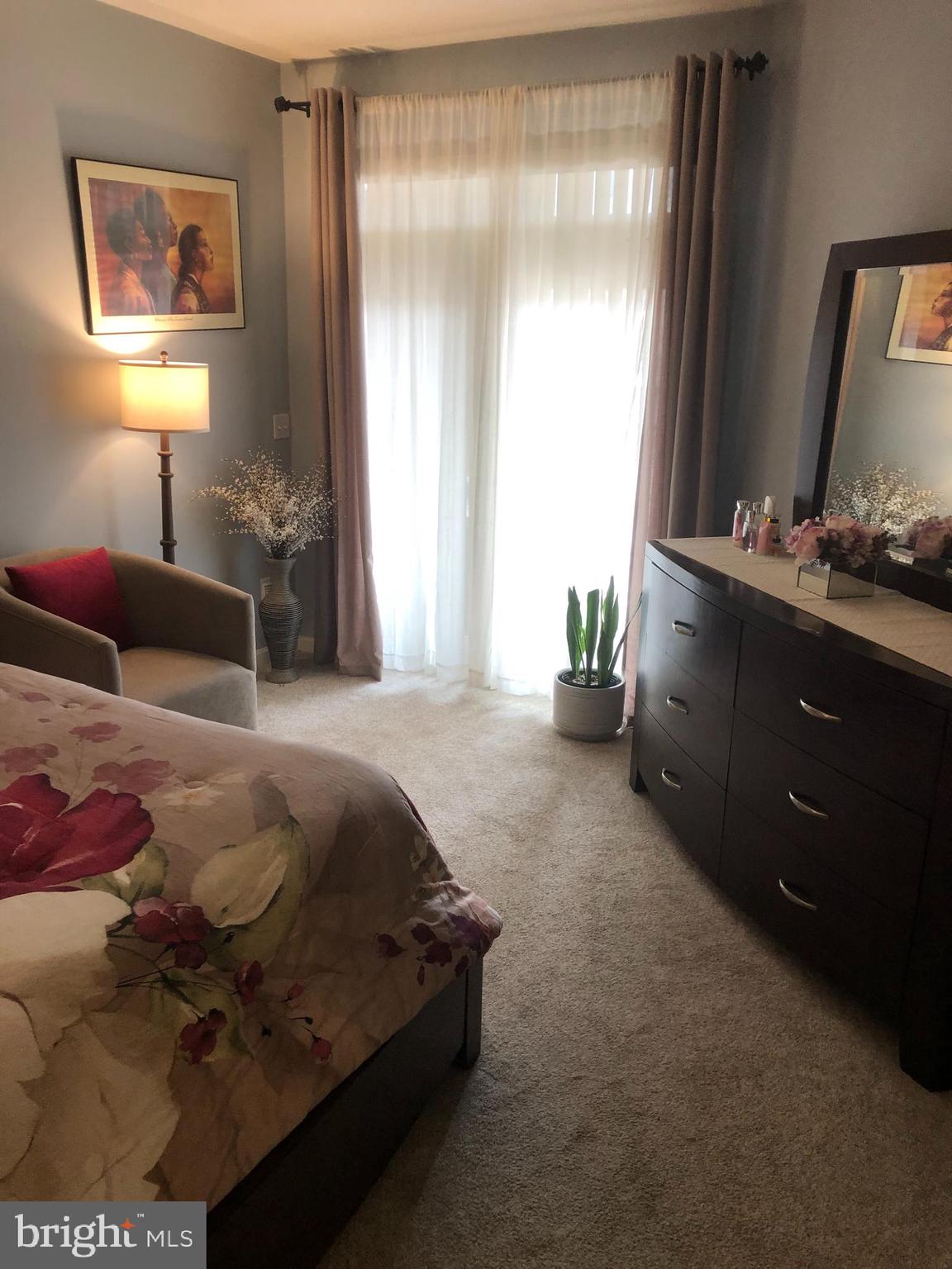 239 Carson Terrace, Unit 239 Huntingdon Valley, PA 19006 - Photo 7 of 19 a bedroom with a bed and a mirror