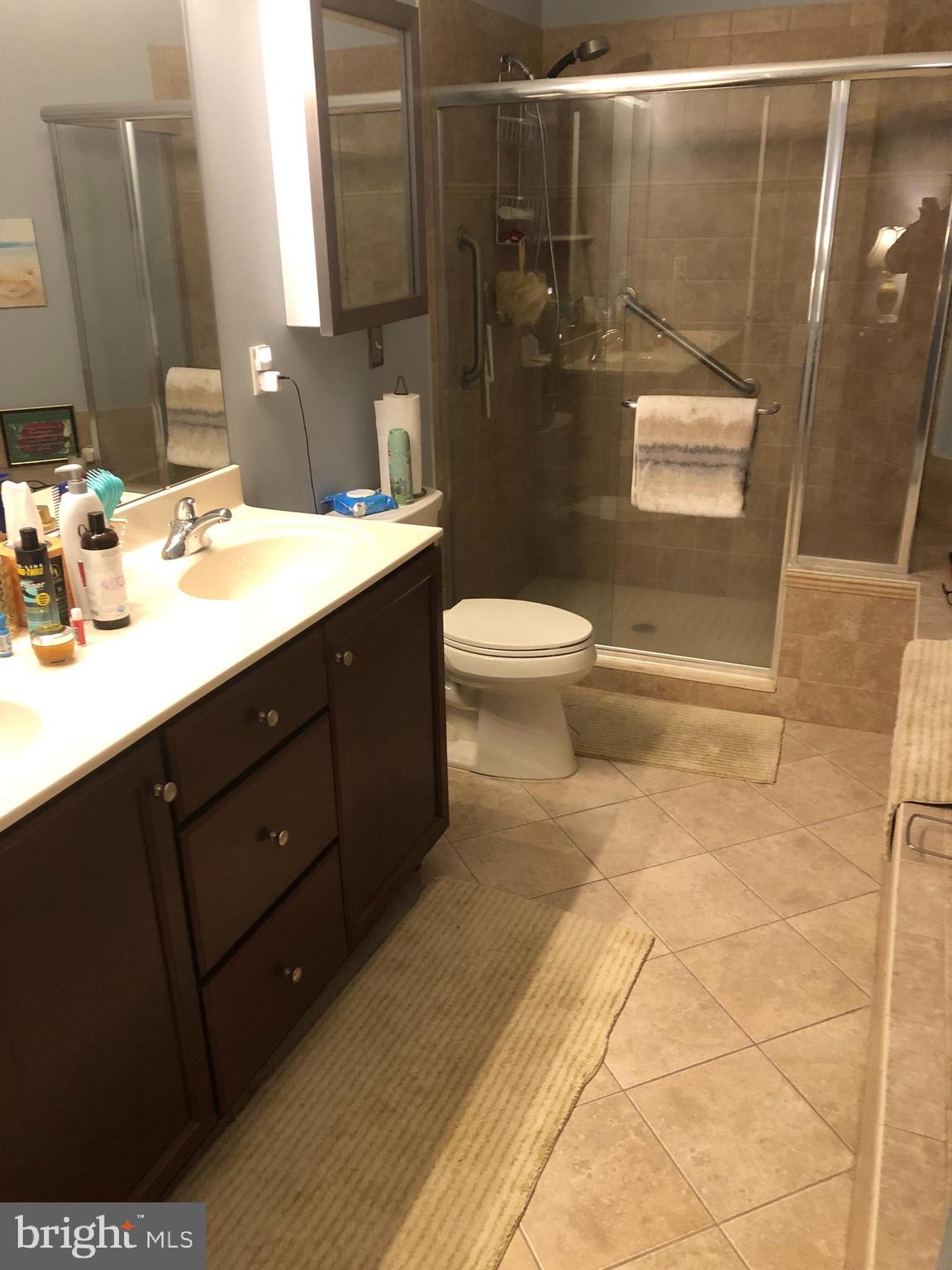 239 Carson Terrace, Unit 239 Huntingdon Valley, PA 19006 - Photo 9 of 19 a bathroom with a sink a toilet and shower