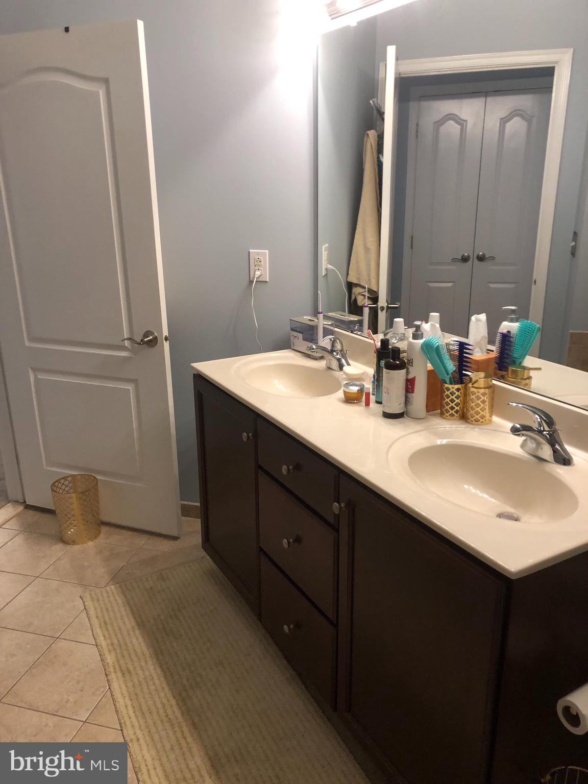 239 Carson Terrace, Unit 239 Huntingdon Valley, PA 19006 - Photo 10 of 19 a bathroom with a double vanity sink and a mirror