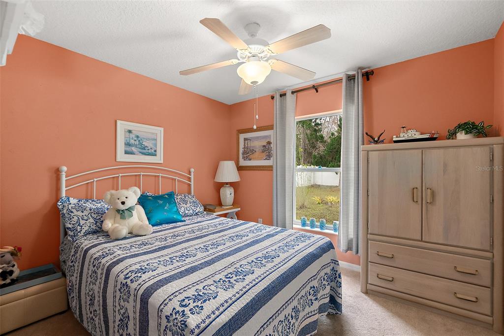 8 Karat Path Palm Coast, FL 32164 - Photo 11 of 37 a bedroom with a large bed and a window