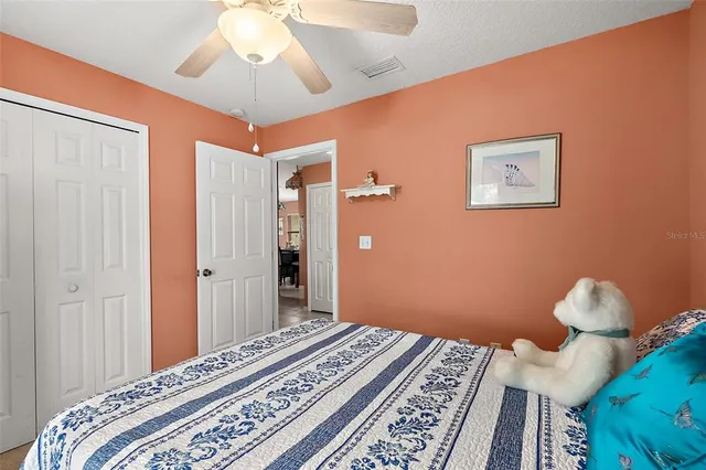a bedroom with bed and wooden floor