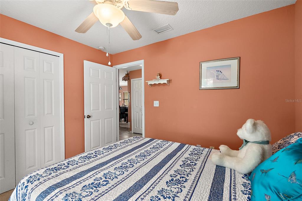 8 Karat Path Palm Coast, FL 32164 - Photo 12 of 37 a bedroom with bed and wooden floor