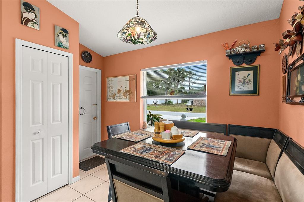 8 Karat Path Palm Coast, FL 32164 - Photo 17 of 37 a view of a dining room with furniture a chandelier and wooden floor