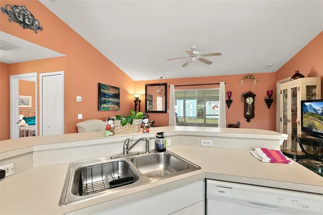 a kitchen with sink and a window