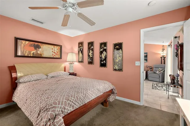 a bedroom with a large bed and a chandelier