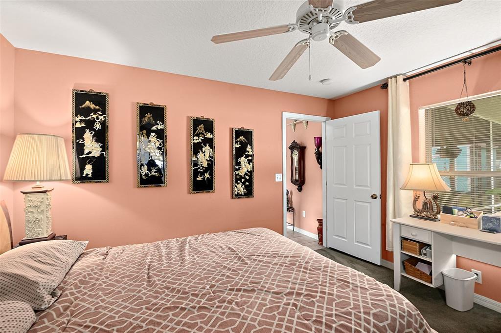 8 Karat Path Palm Coast, FL 32164 - Photo 24 of 37 a bedroom with a large bed and a chandelier