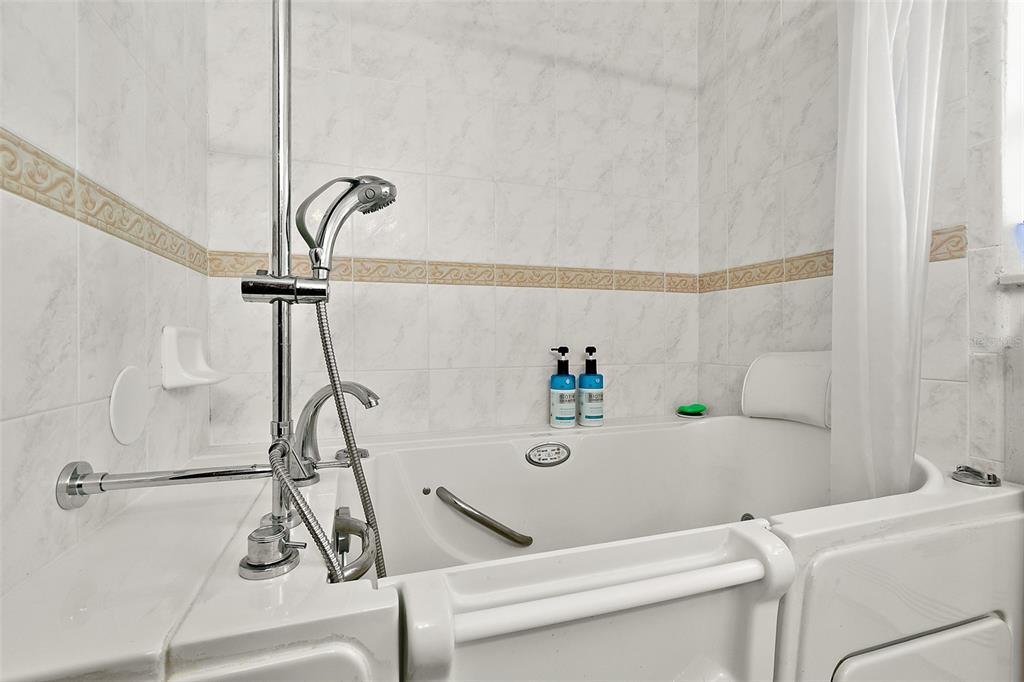 8 Karat Path Palm Coast, FL 32164 - Photo 26 of 37 a bath tub sitting next to a white sink and a shower