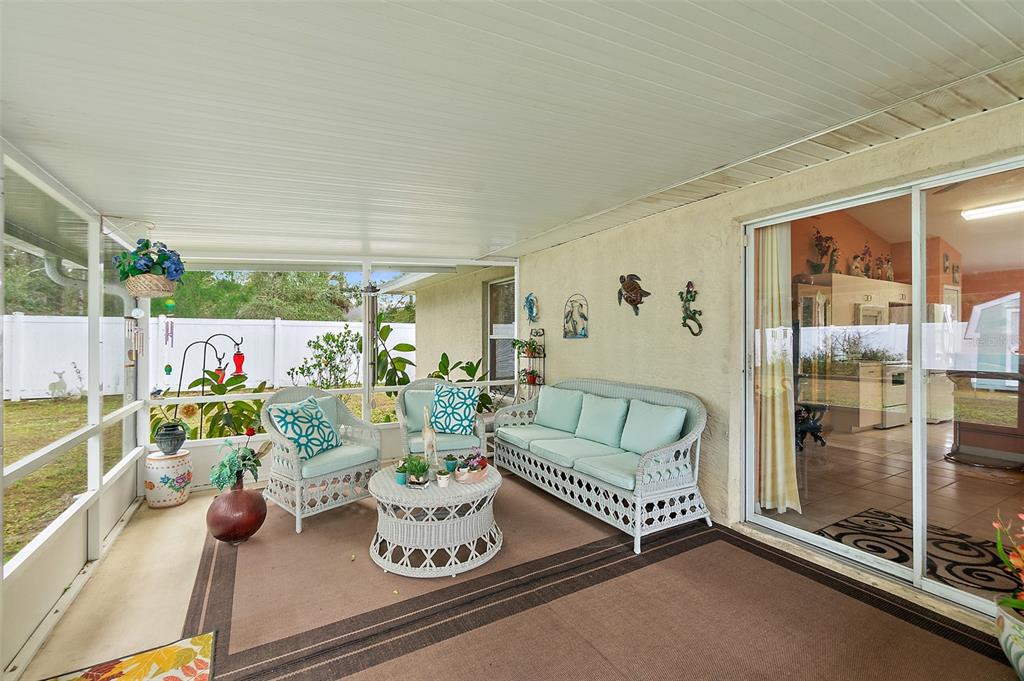 8 Karat Path Palm Coast, FL 32164 - Photo 29 of 37 a living room with furniture and a floor to ceiling window