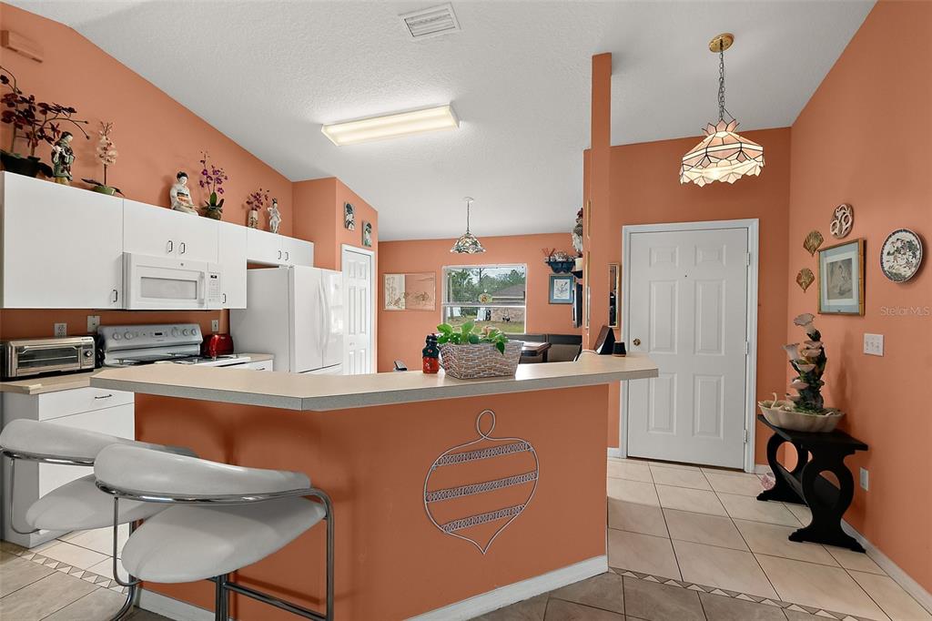 8 Karat Path Palm Coast, FL 32164 - Photo 9 of 37 a kitchen with stainless steel appliances granite countertop a sink counter space and chairs