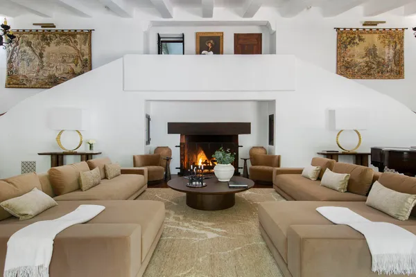 a view of a bench in a tree next to a yard