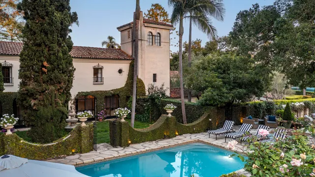 a view of a patio with couches table and chairs and potted plants